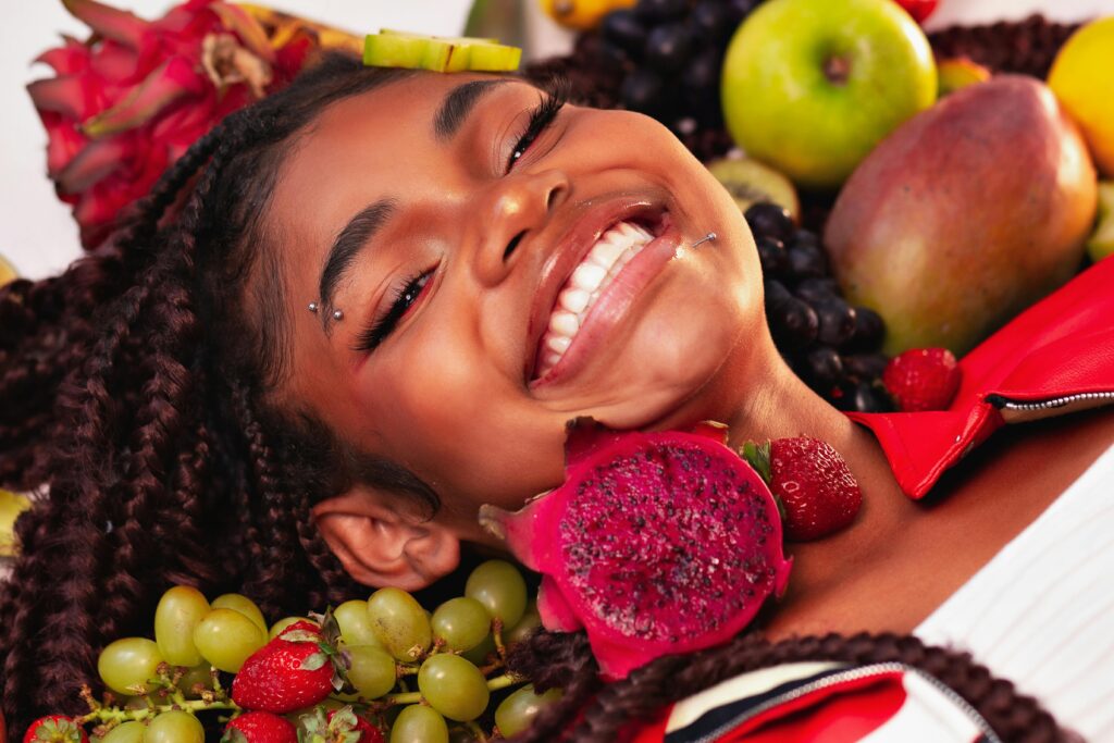 pexels-photo-30890395-30890395 Joyful girl surrounded by vibrant tropical fruits in Brazil, showcasing natural beauty and happiness.